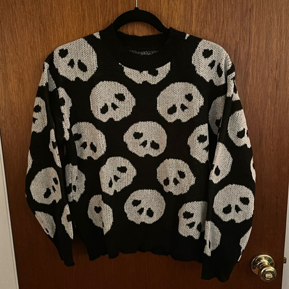 Black knit sweater with white skull design all over. Shein